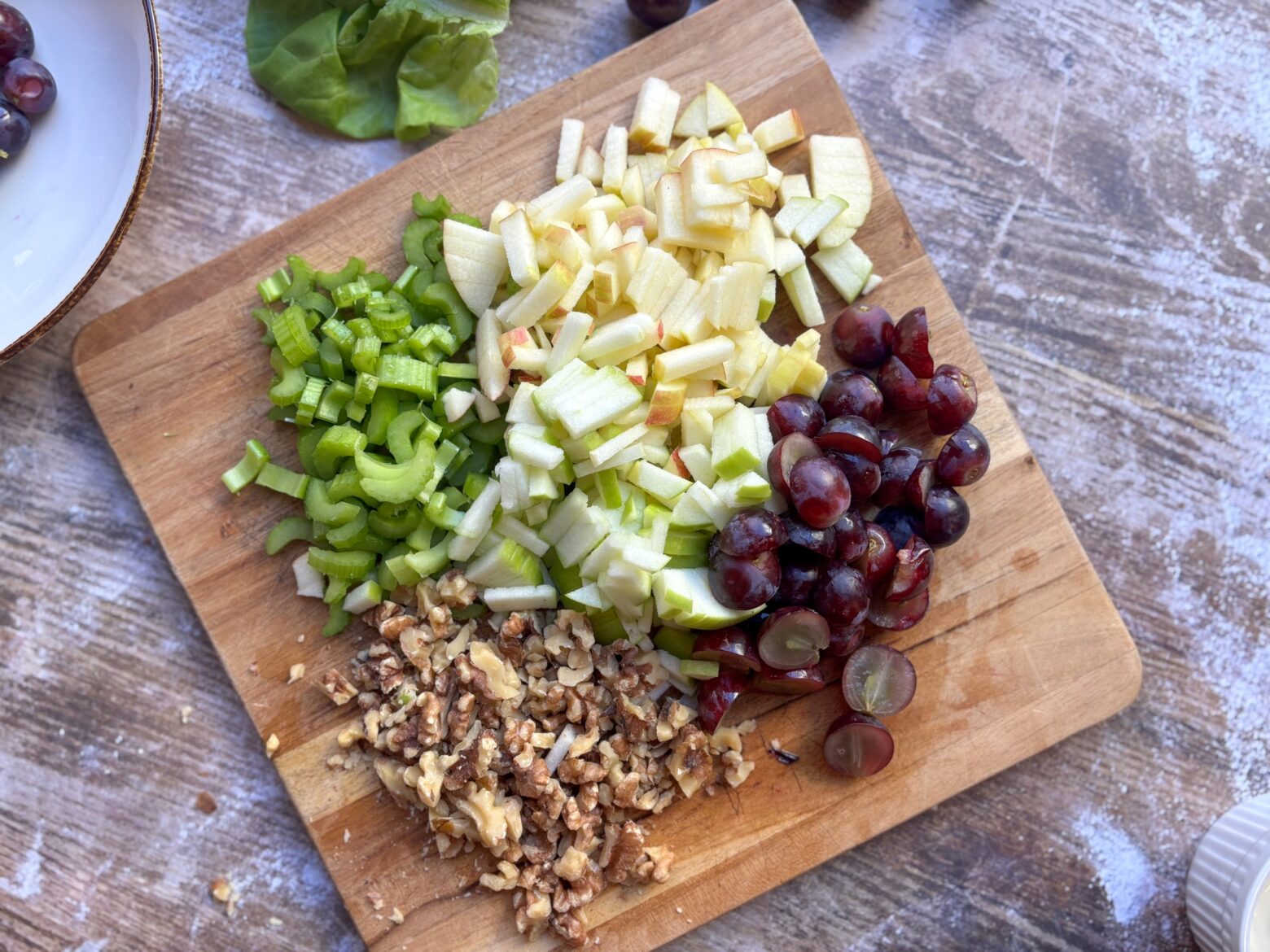 Waldorf Salad ingredients chopped on a cutting board.