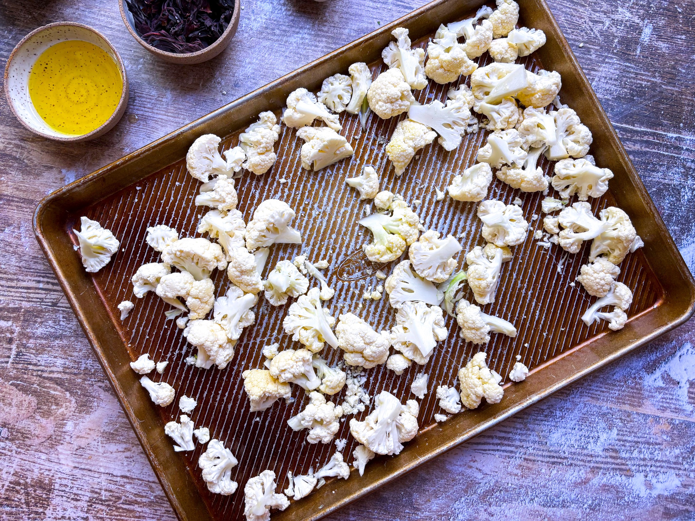 Cauliflower on a sheet pan, ready for roasting.