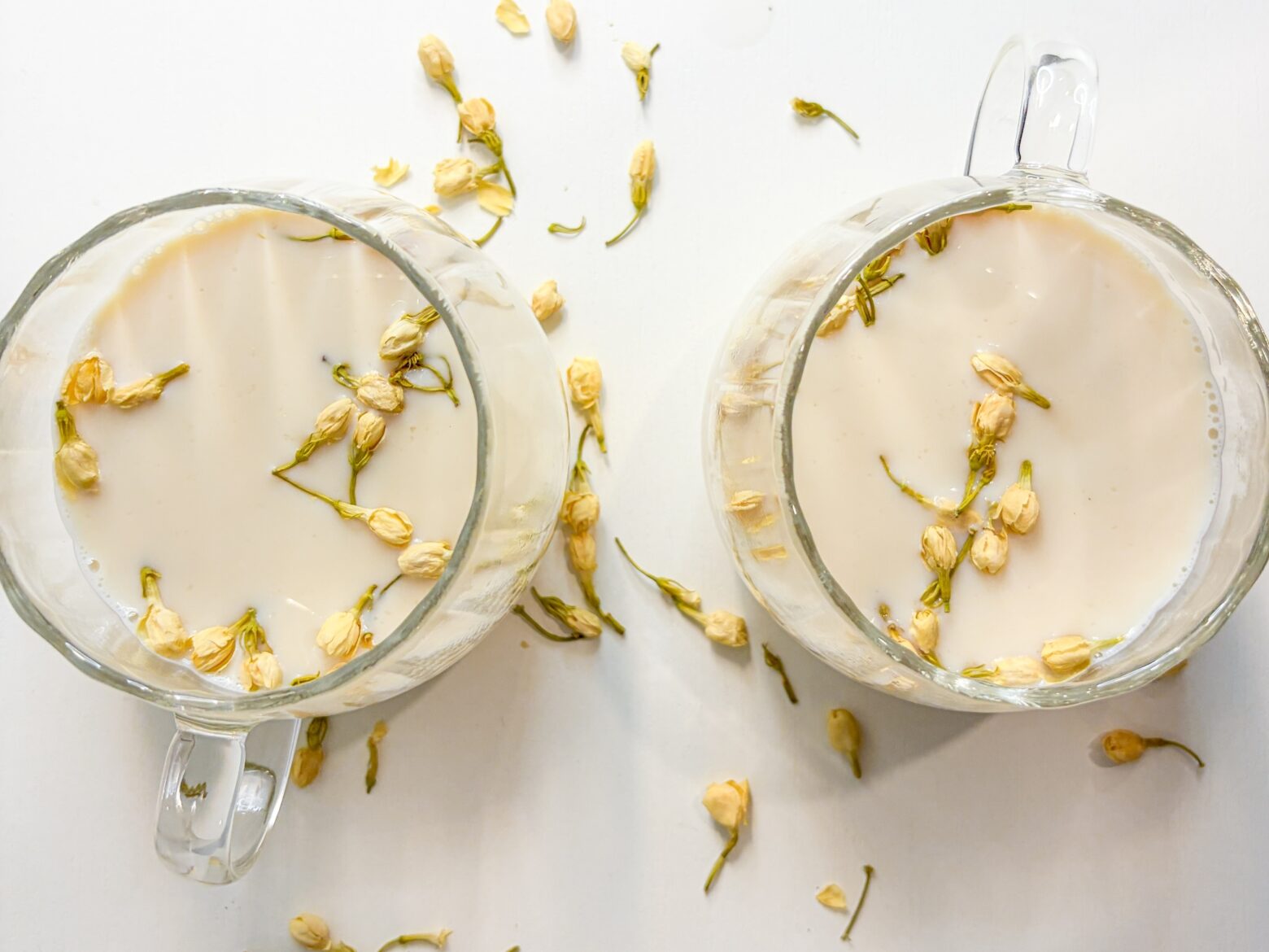 Jasmine Green Tea Lattes divided between two glass mugs.