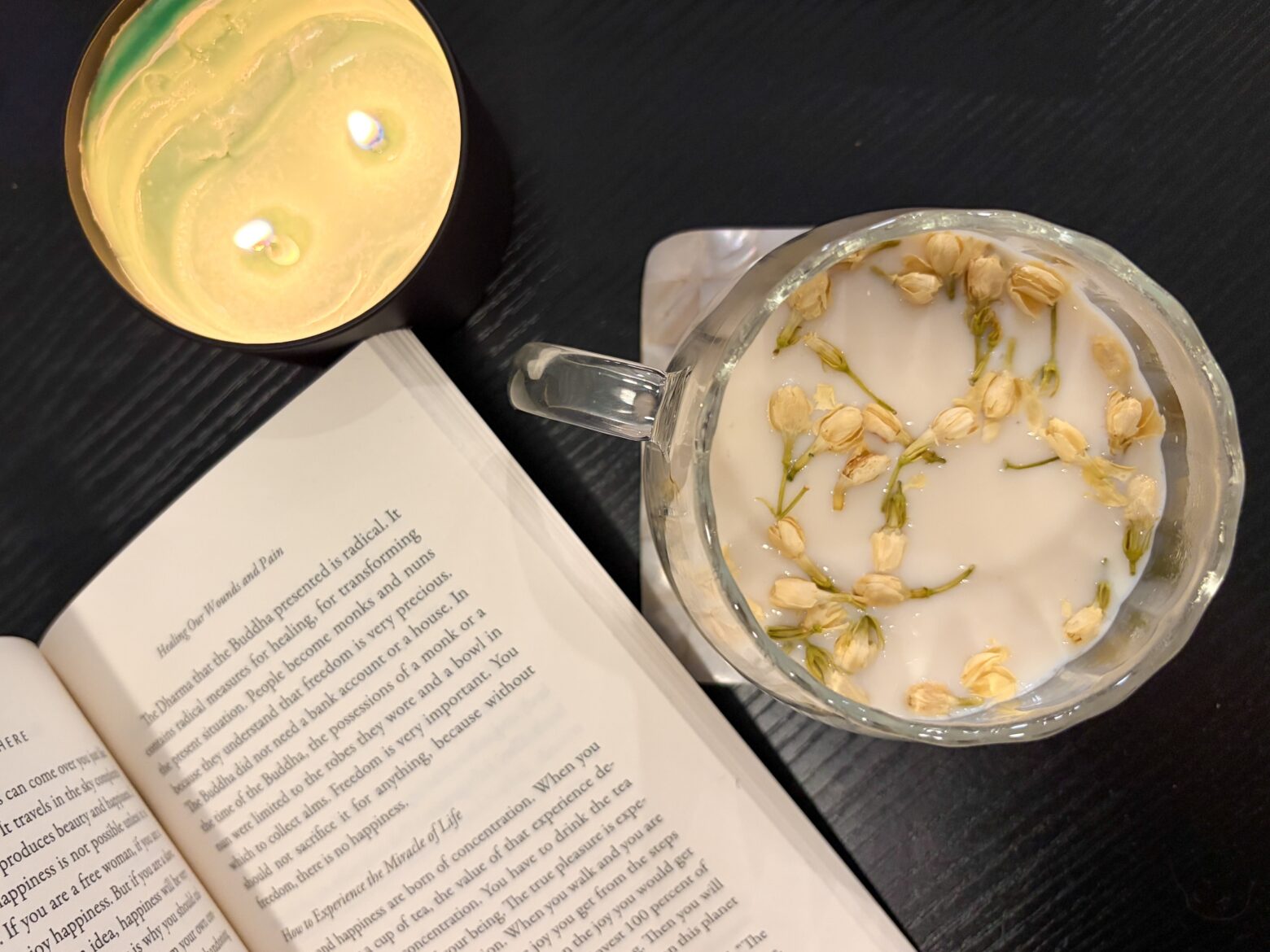 Jasmine Green Tea Latte with a candle and a book.