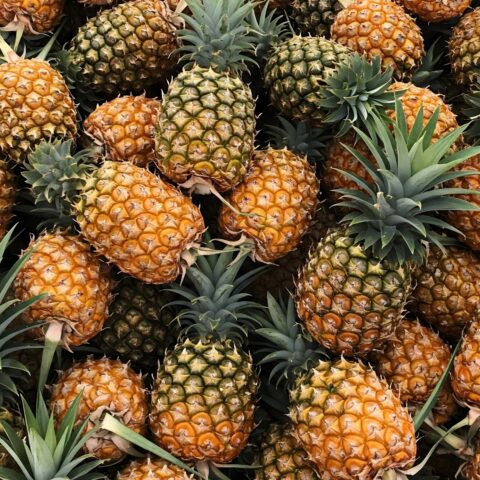 A pile of fresh, whole pineapples