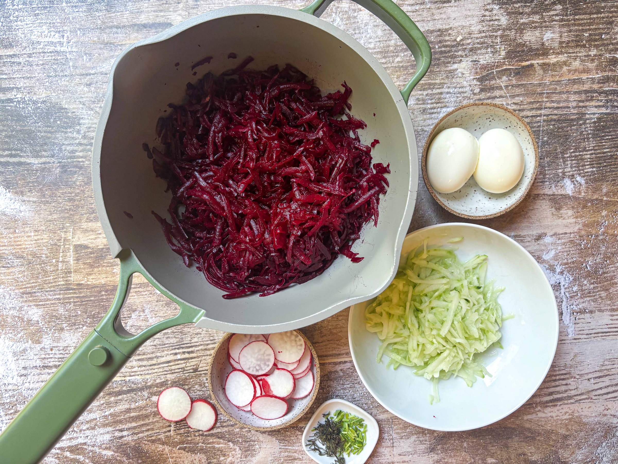 Shredded beets and cucumber in separate containers
