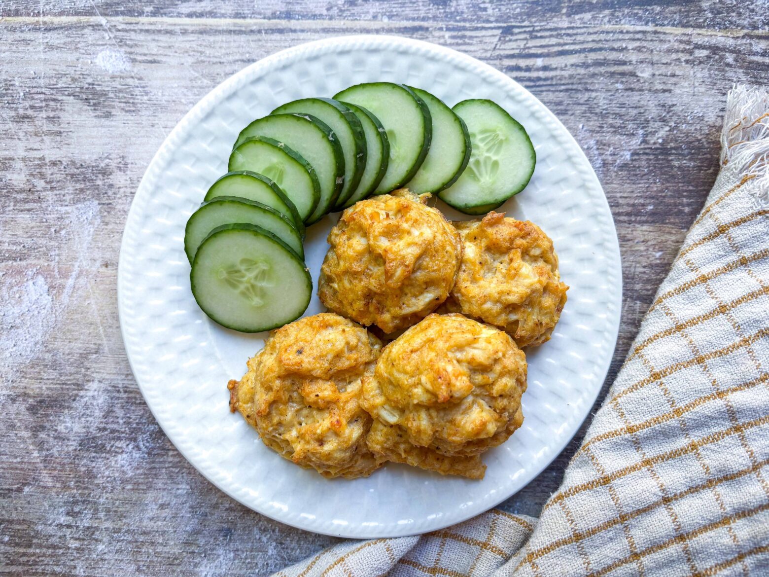 Stuffed Crab filling on a plate with cucumber.