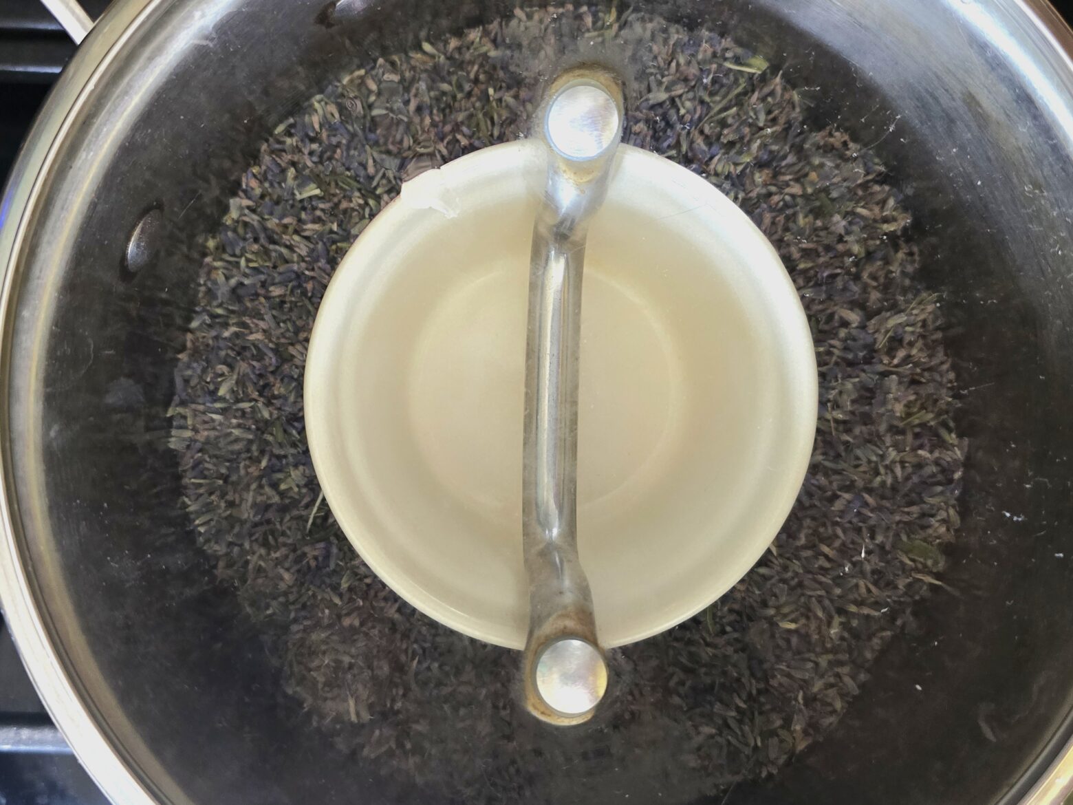 Lavender buds in a pot around a small bowl
