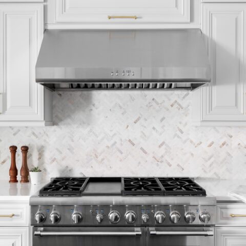 An oven range with a kitchen ventilation hood in a white kitchen.