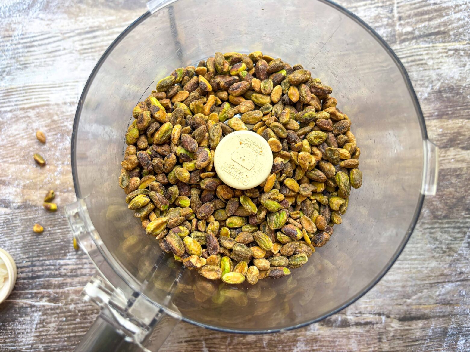 Pistachios in a food processor before blending.