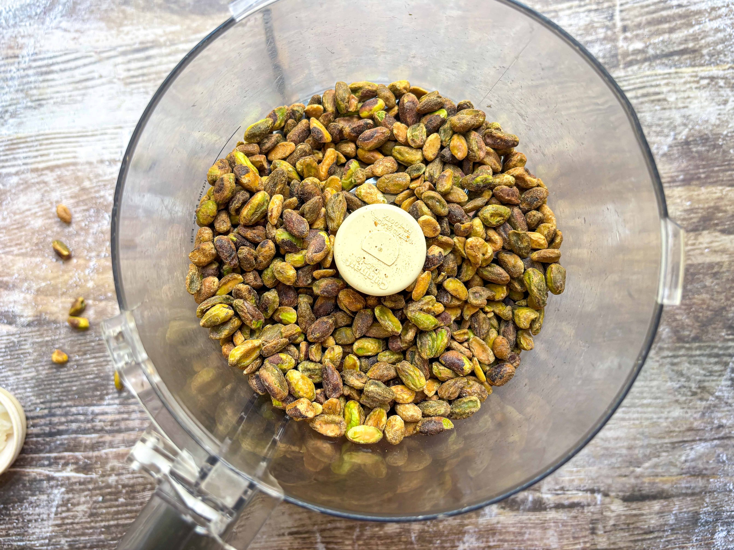 Pistachios in a food processor before blending.