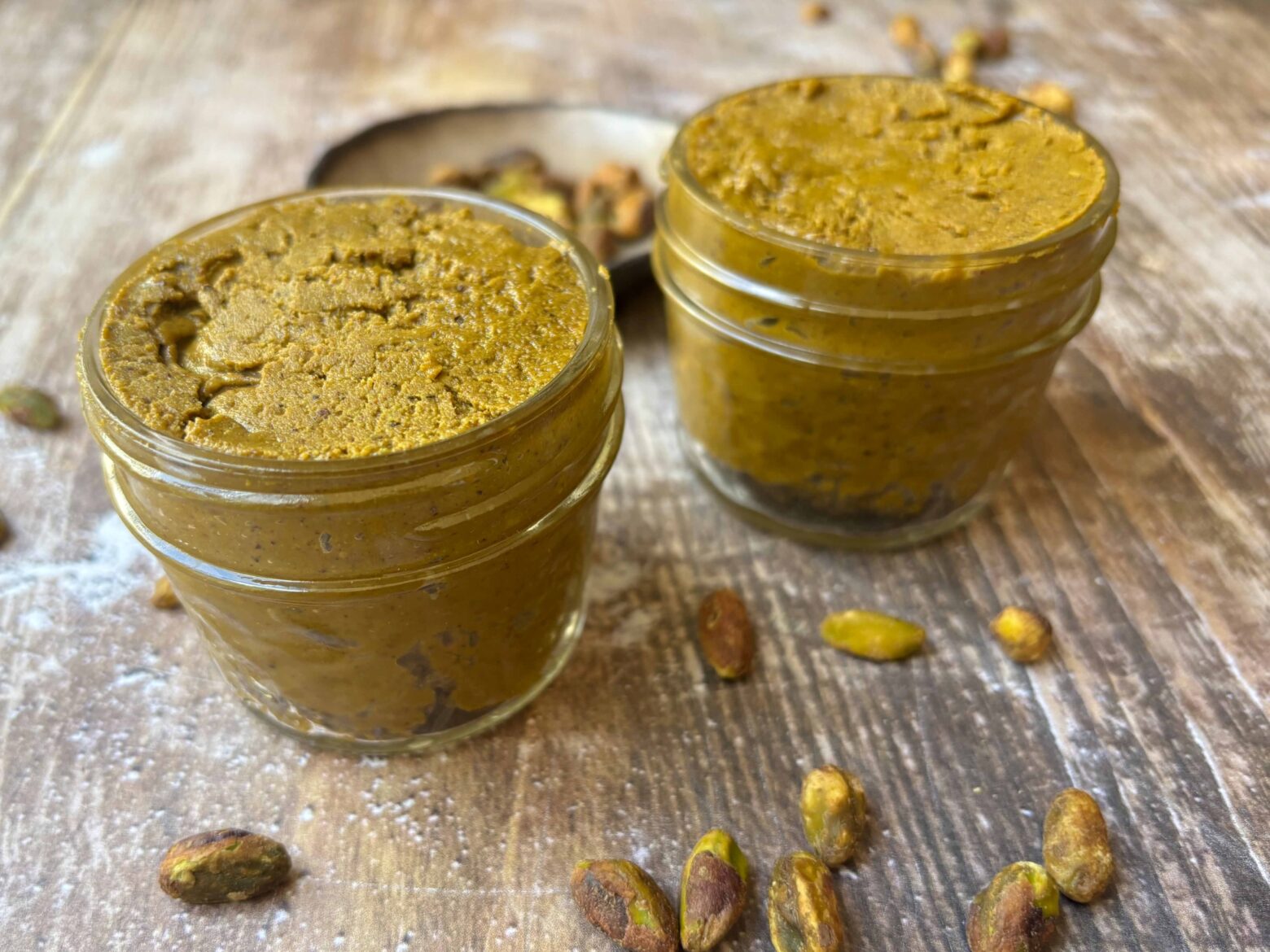 Pistachio butter in two small jars.