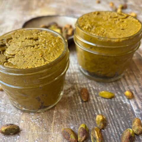 Pistachio butter in two small jars.