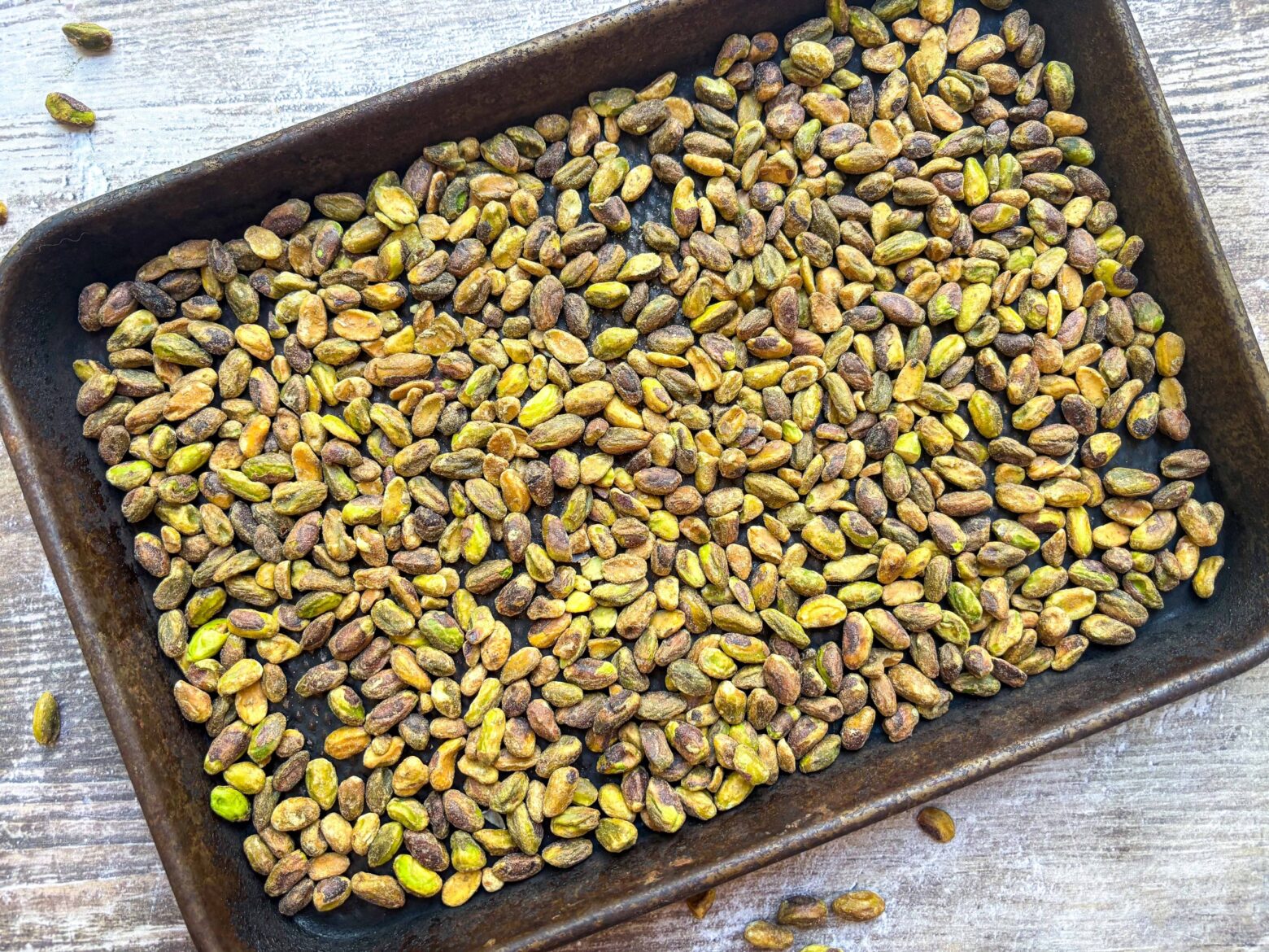 Pistachios roasted on a pan.