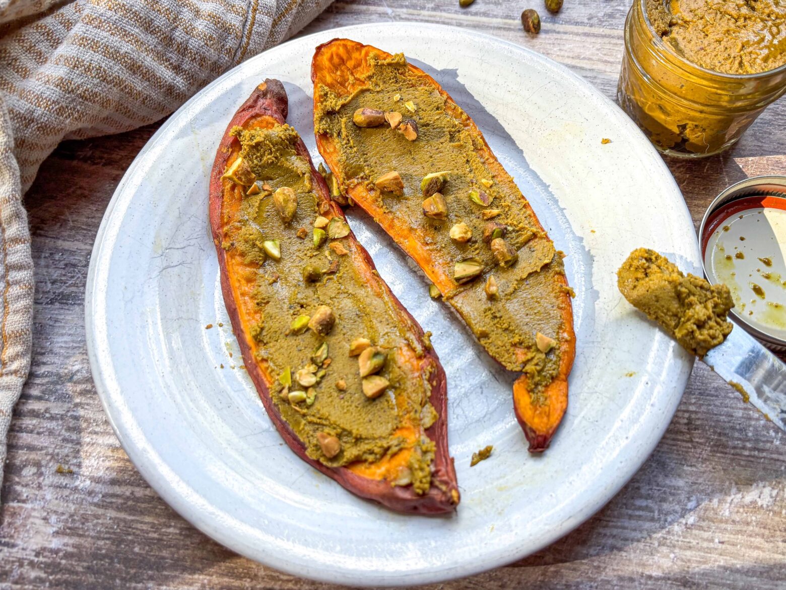 Pistachio butter spread on slices of sweet potato.