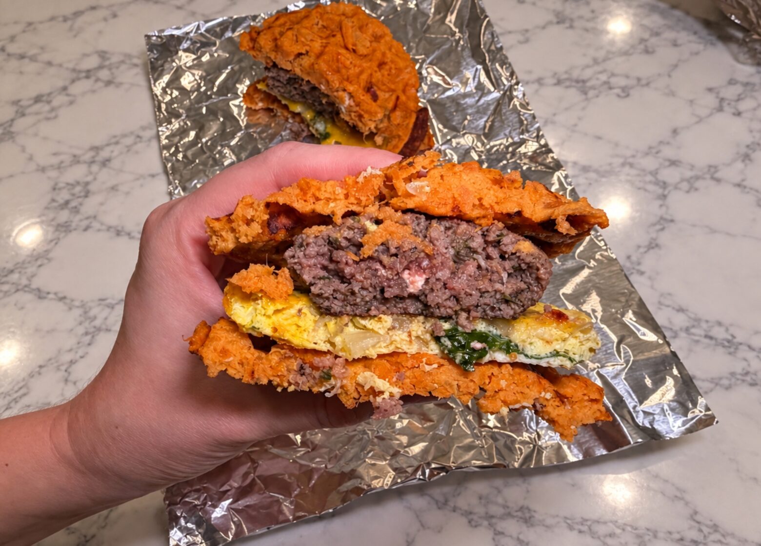 Assembled breakfast sandwich cut in half.