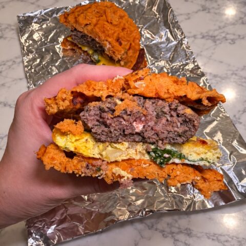 Assembled breakfast sandwich cut in half.