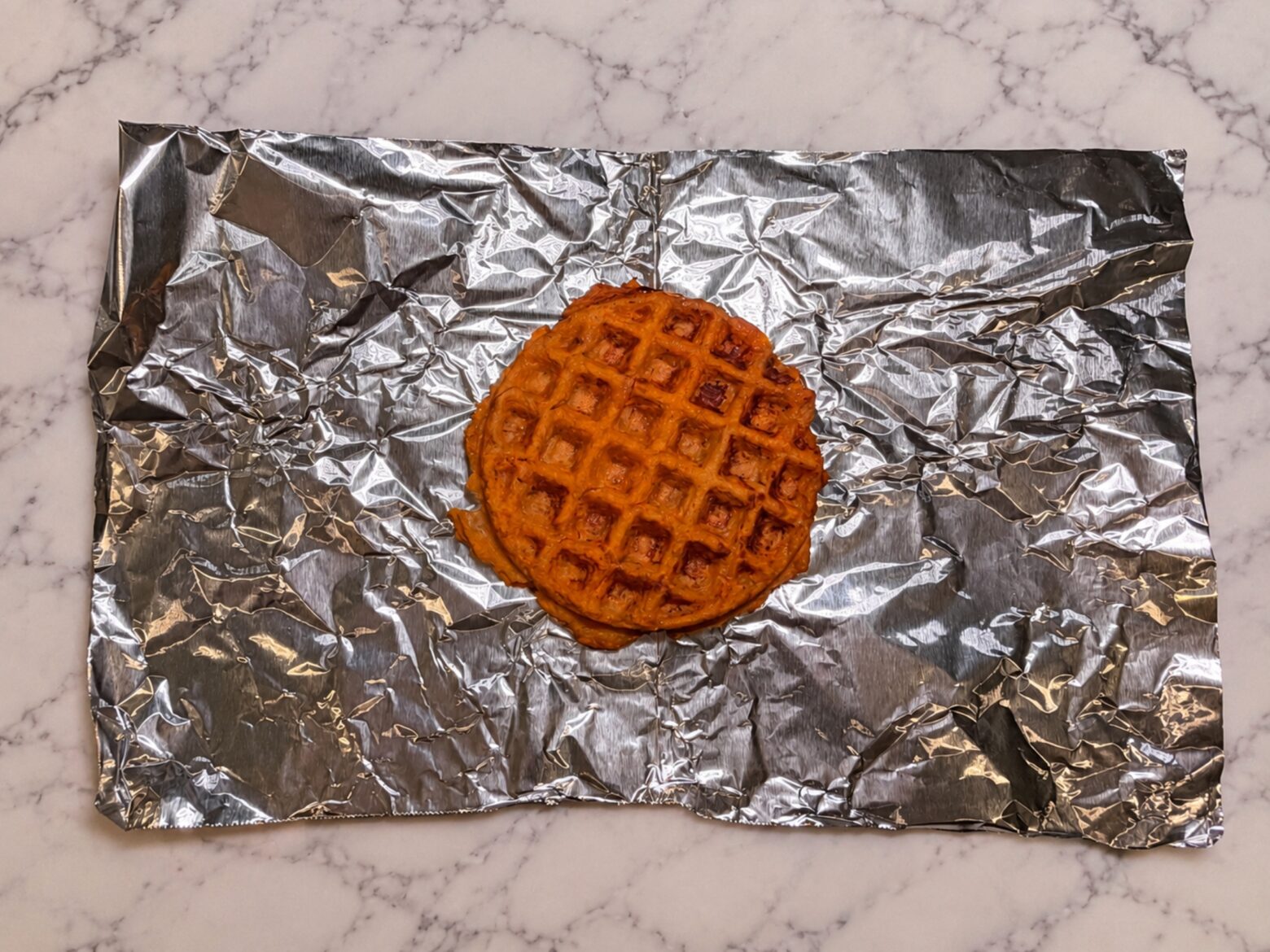 Sweet potato waffle on tin foil.