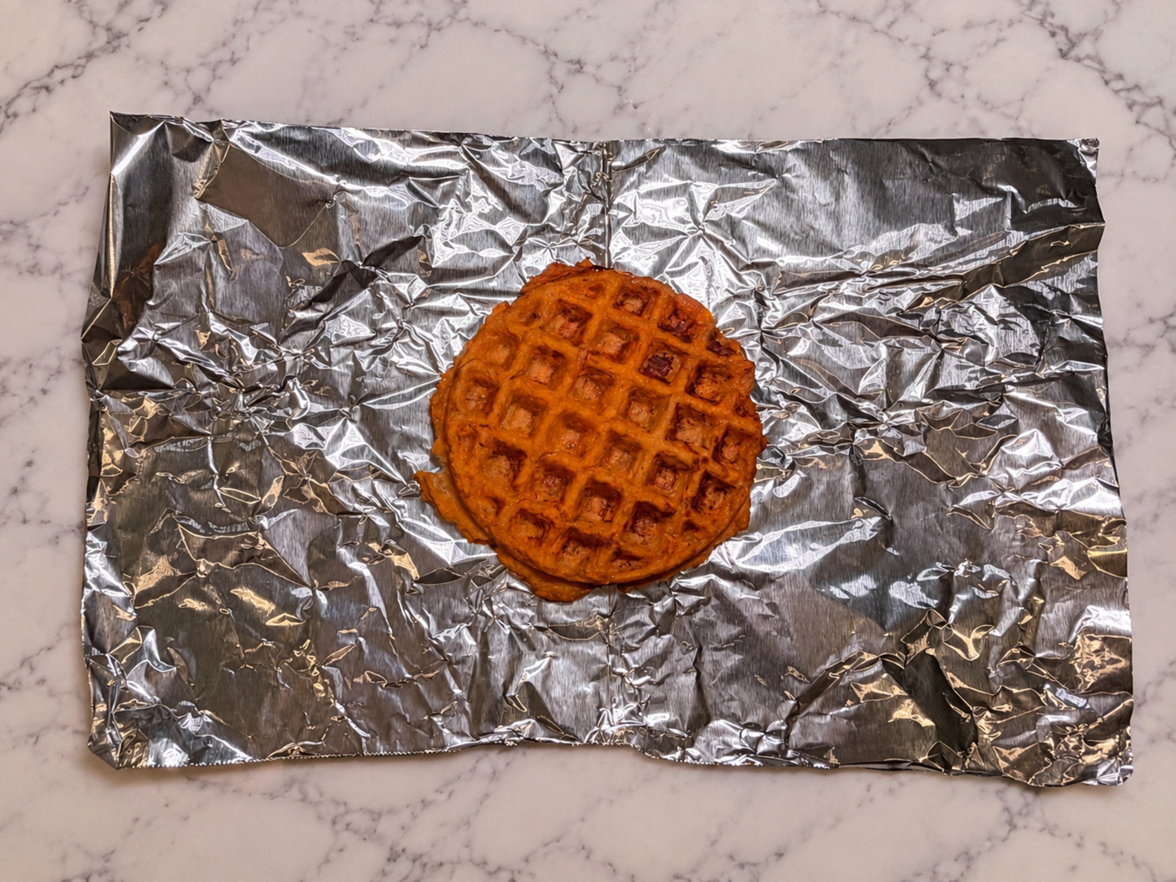 Sweet potato waffle on tin foil.