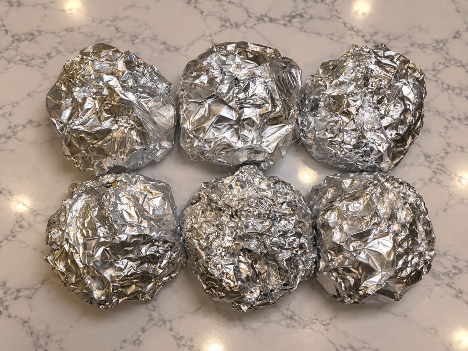 Finished breakfast sandwiches individually wrapped in foil.