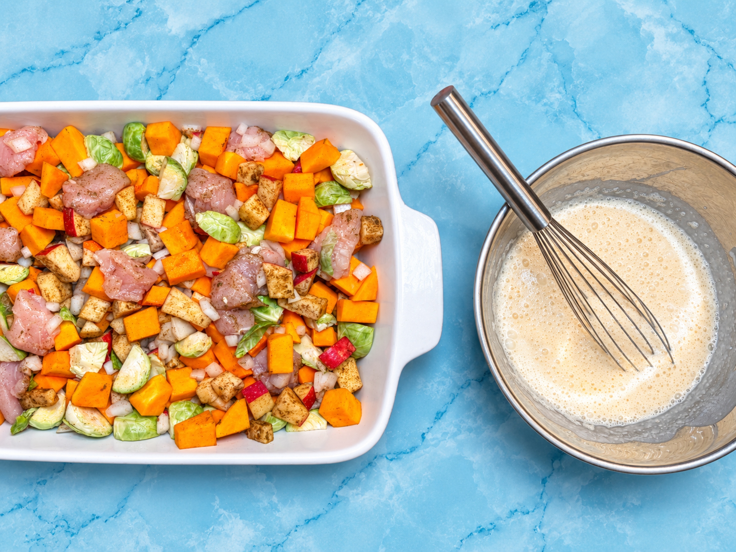 Fall chicken casserole ingredients with liquids mixed on the side.